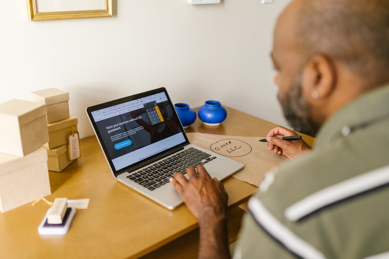 home-hero Entrepreneur at a desk using a laptop for business planning. Ideal for tech and startup themes.
